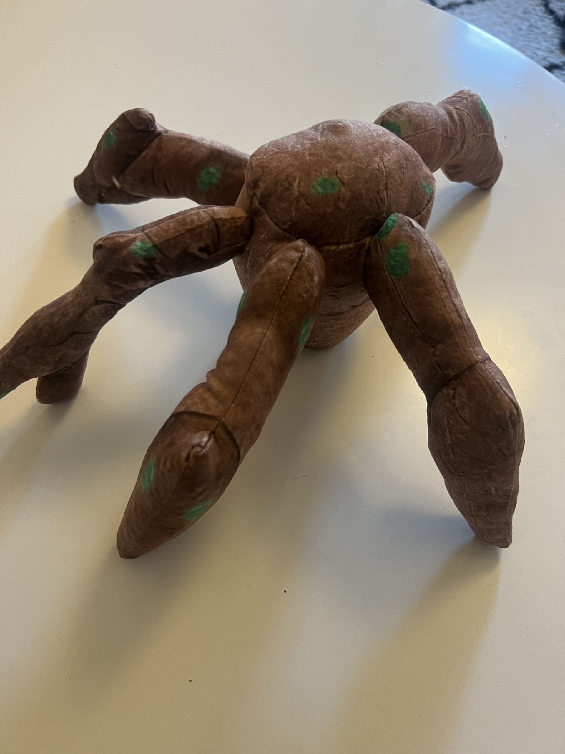 Project Hail Mary Rocky plush positioned upright in a standing attempt