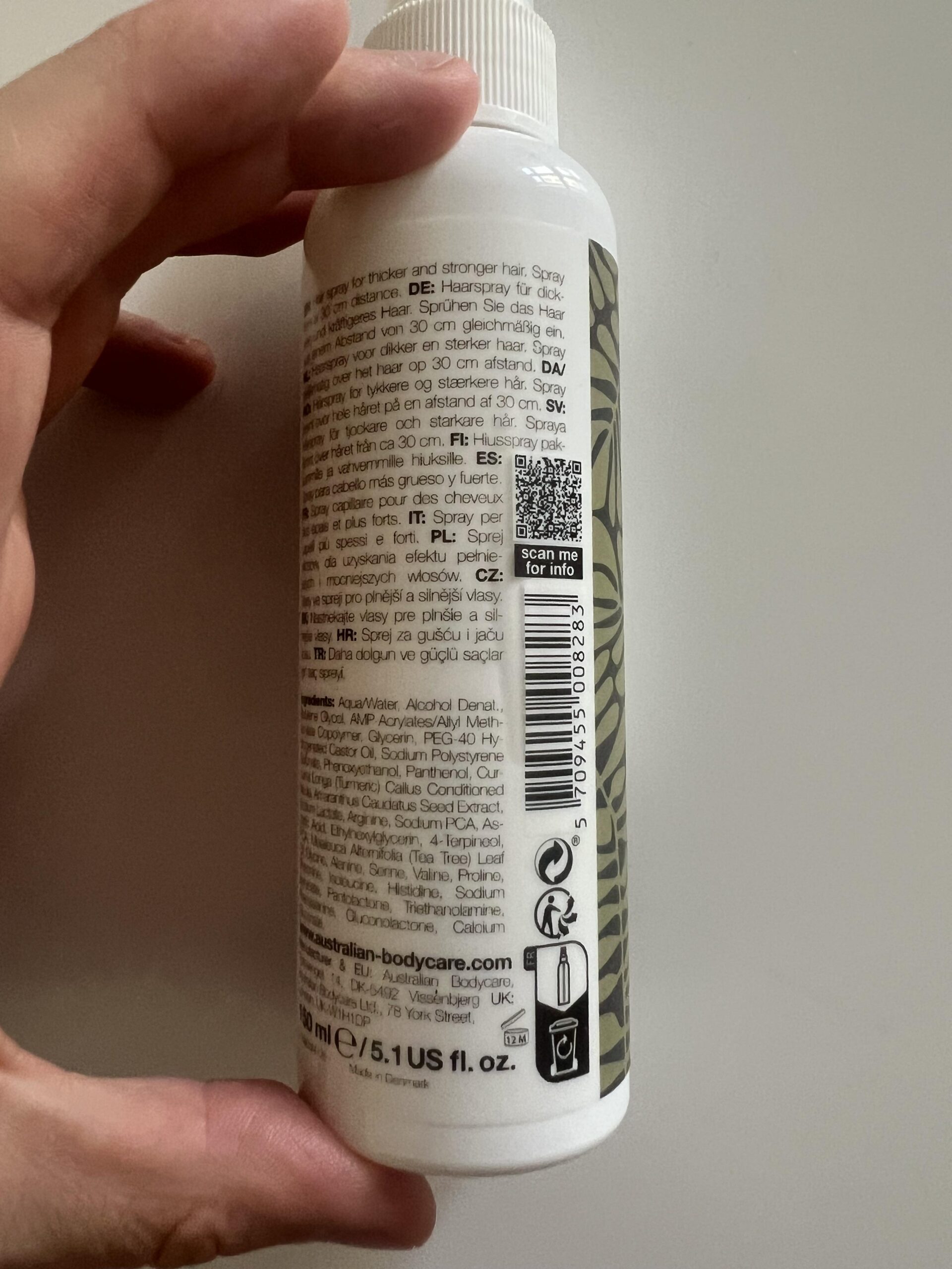 Side of the Australian Bodycare Hair Loss Spray showing its barcode, instructions and cosmetic open-jar 12M marking