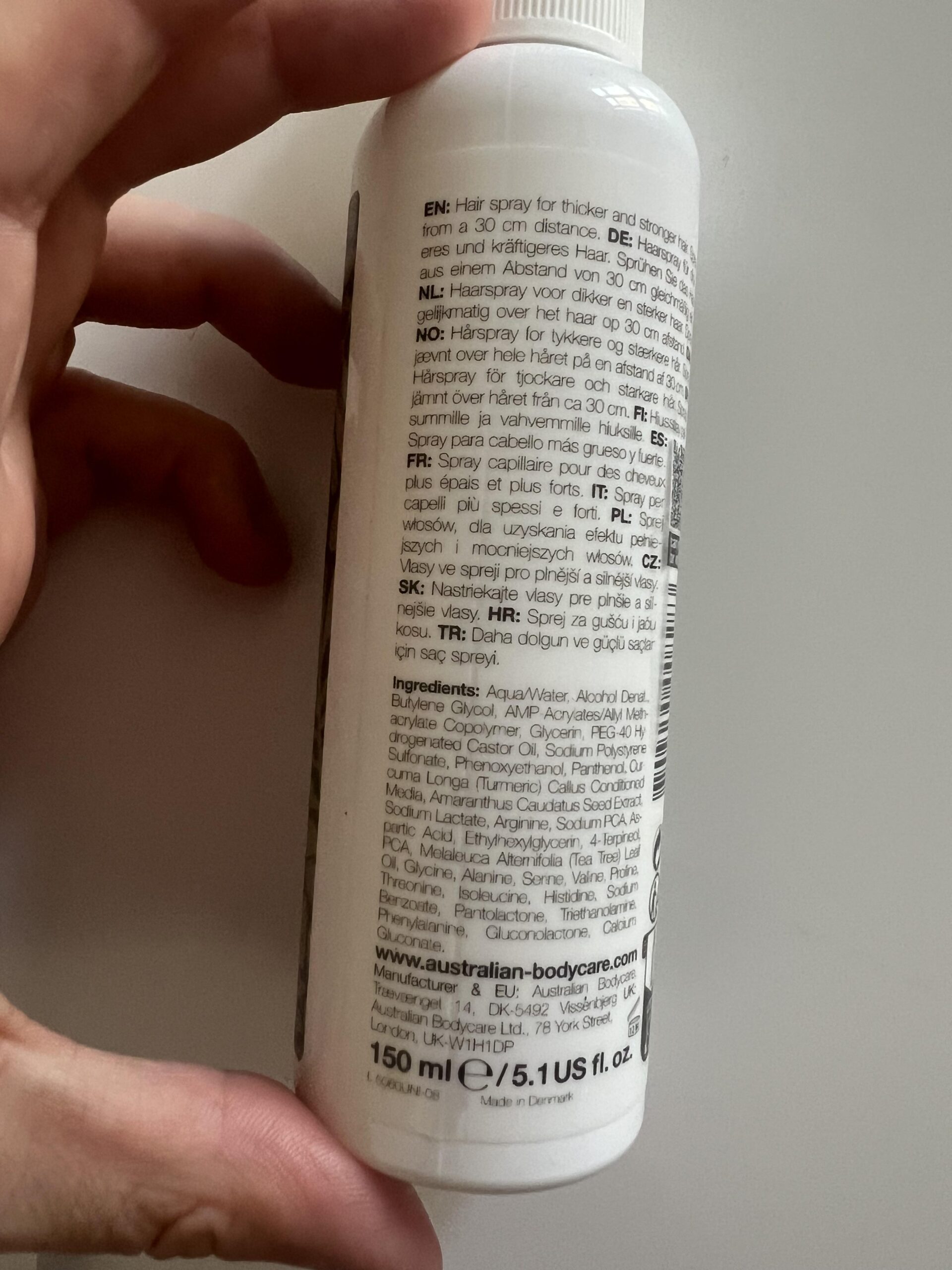 Close-up of the original 2024 Australian Bodycare Hair Loss Spray bottle's ingredient list and multilingual instructions