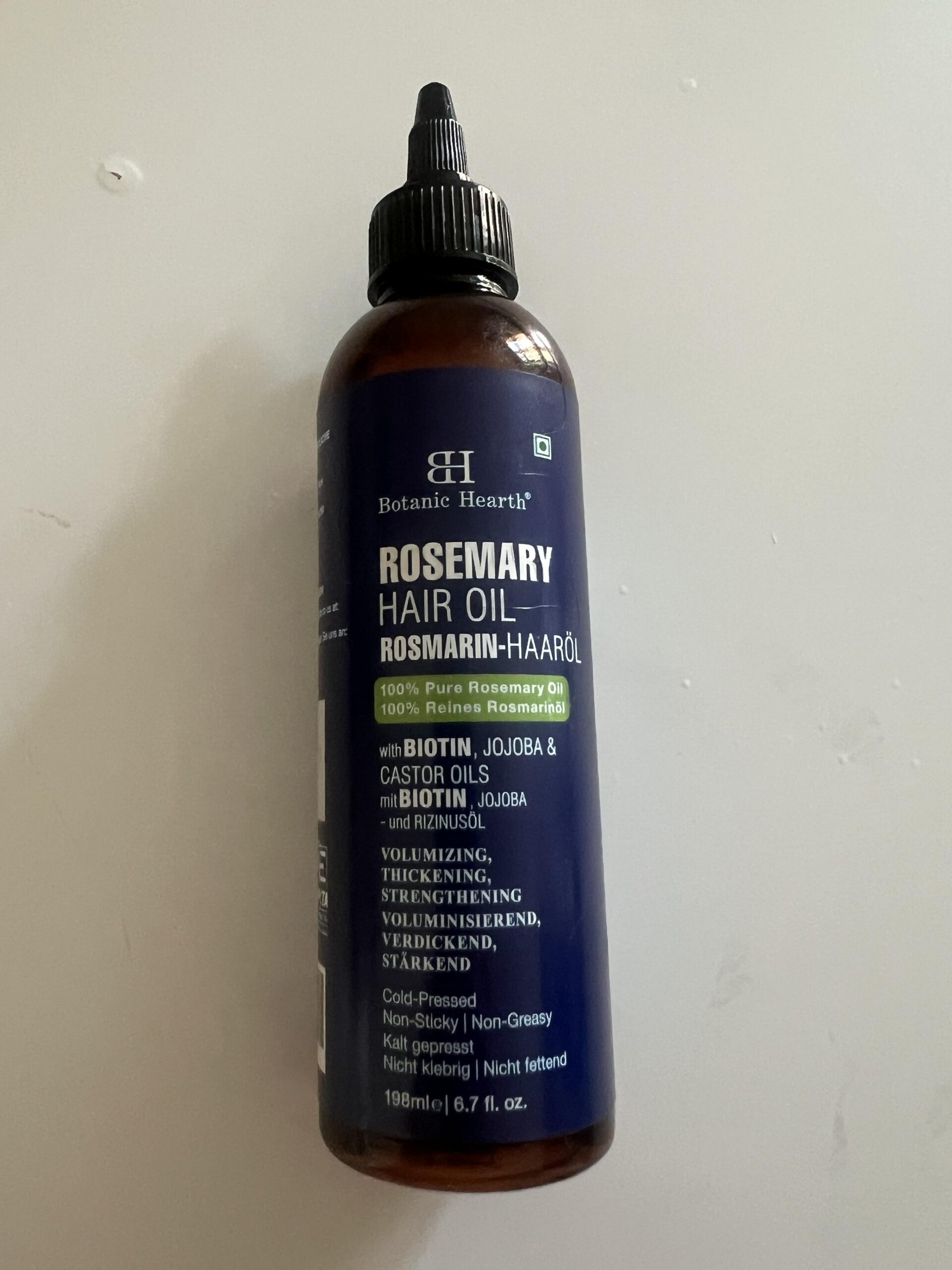 Original photograph of a Botanic Hearth Rosemary Hair Oil 198 ml bottle showing the front label