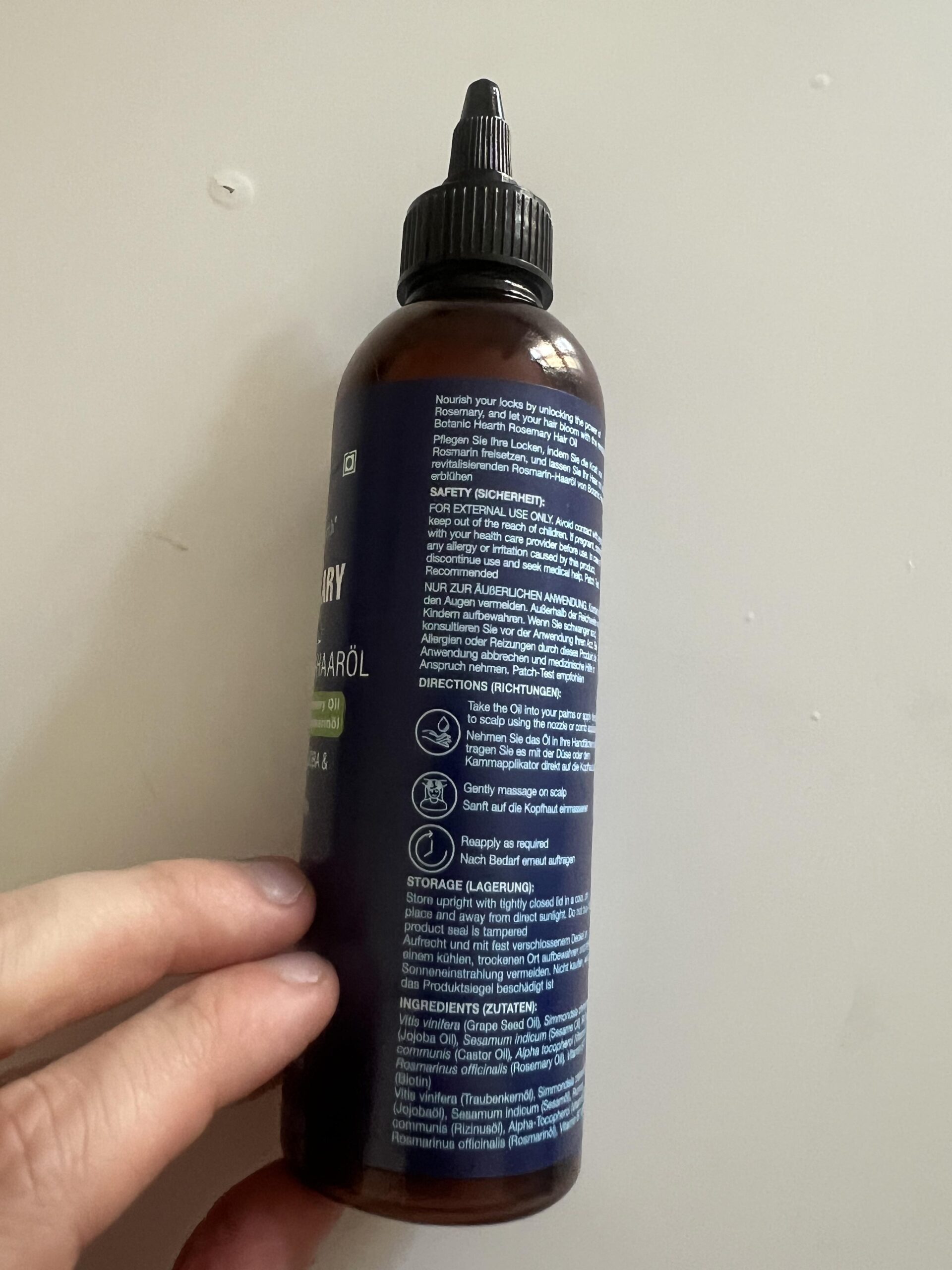 Side of Botanic Hearth Rosemary Hair Oil bottle showing ingredients and directions