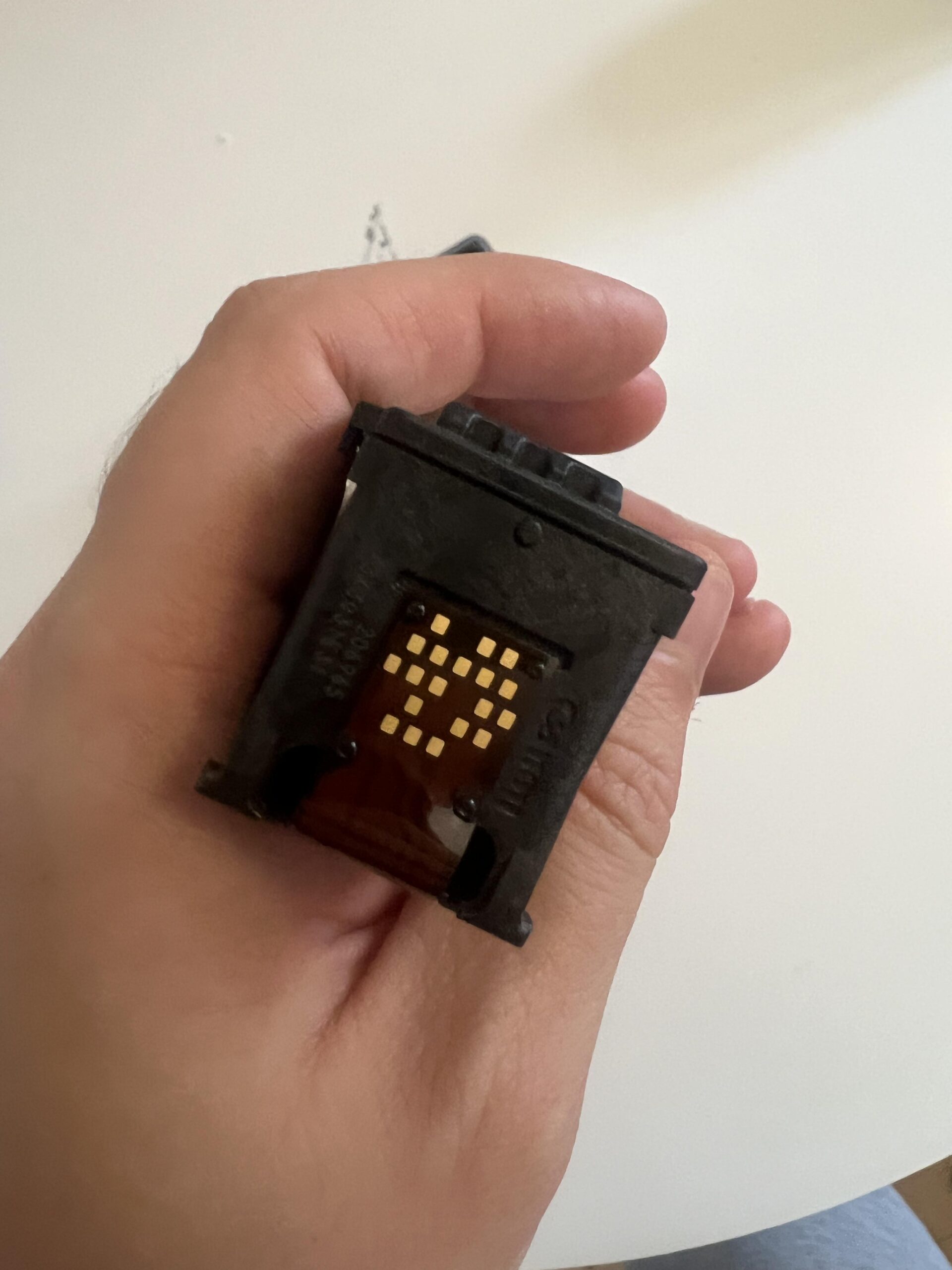 Copper electrical contact pads on the reverse side of a Canon PG-545XL Black cartridge