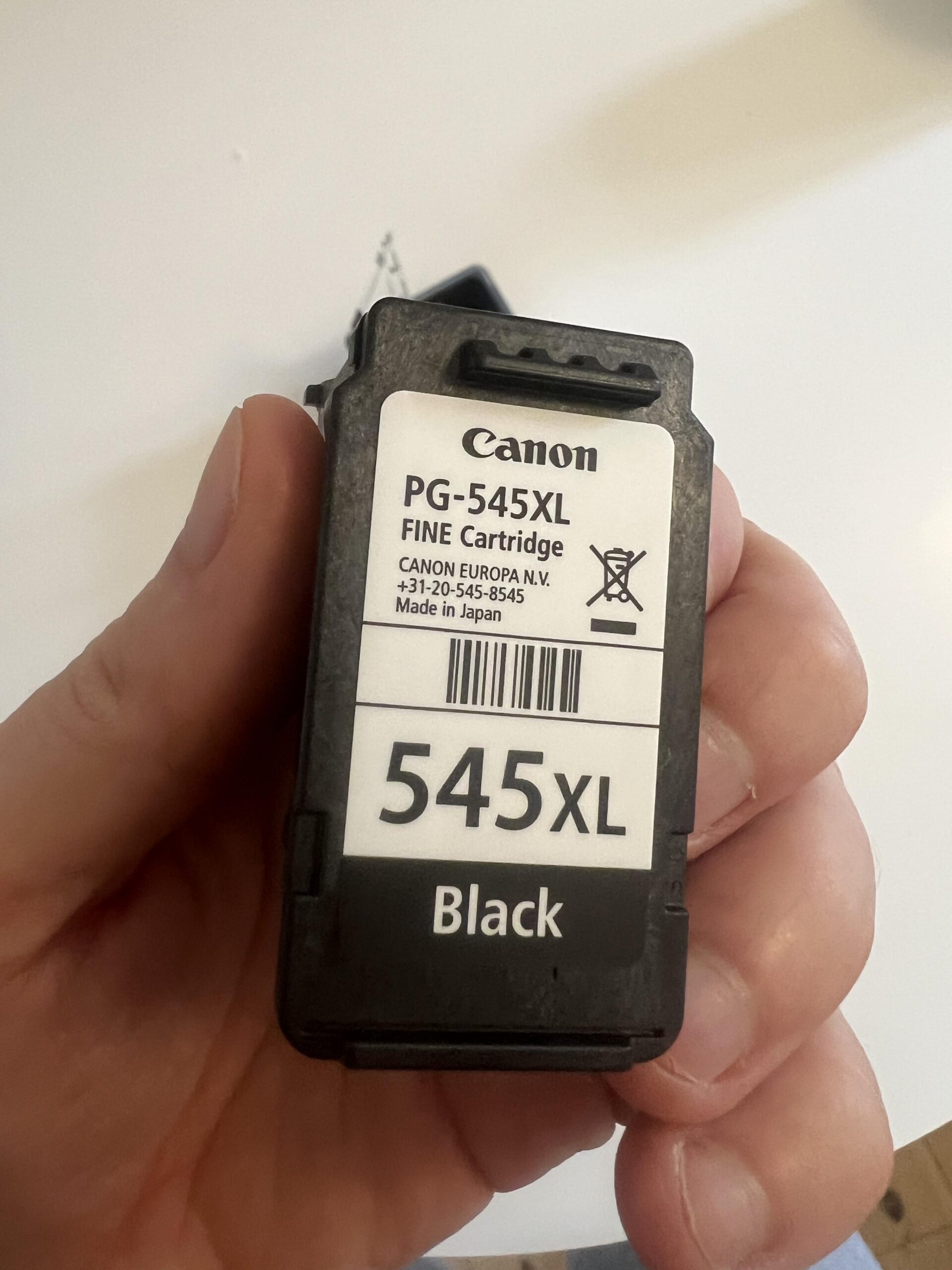 Black Canon PG-545XL ink cartridge held in hand with original label clearly visible