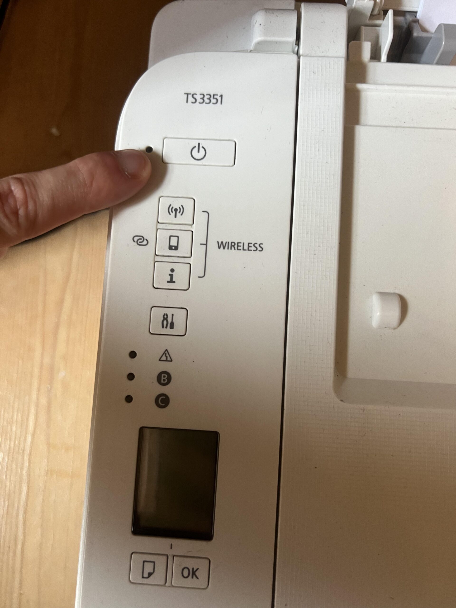 Close-up of TS3351 model number printed by the wireless controls on the white Canon PIXMA