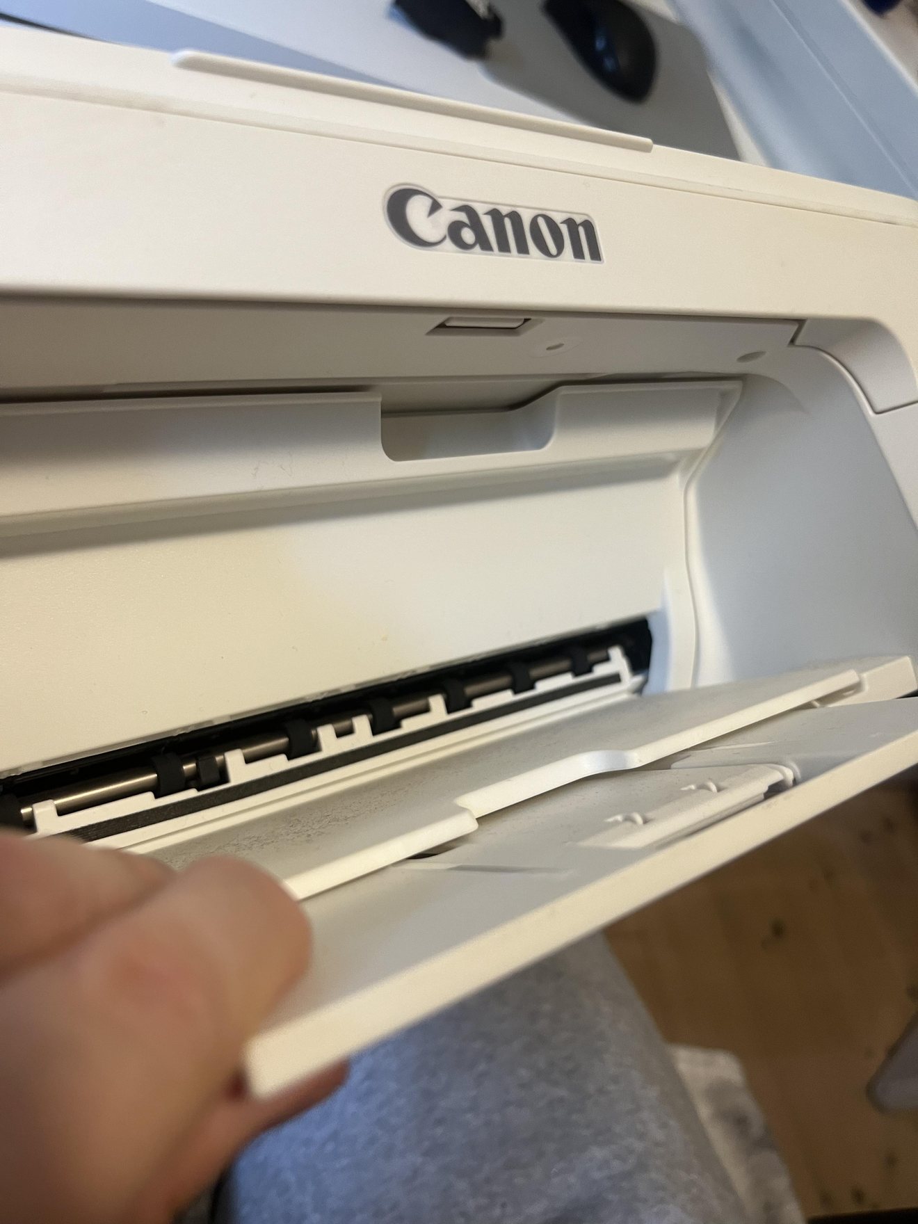 Front paper output tray open on the white Canon PIXMA TS3351