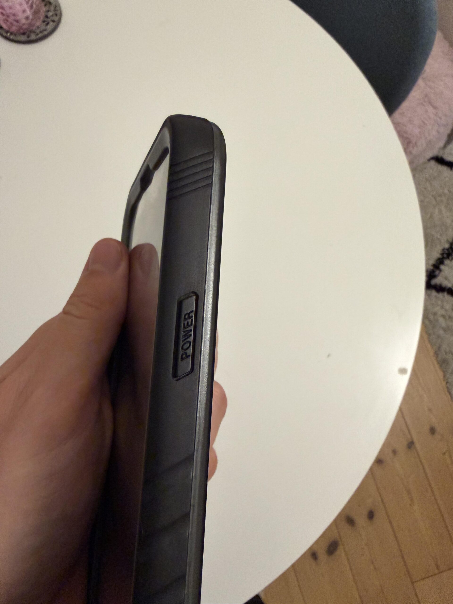 Side view of the power button on my black Cozycase waterproof iPhone 13 Pro case