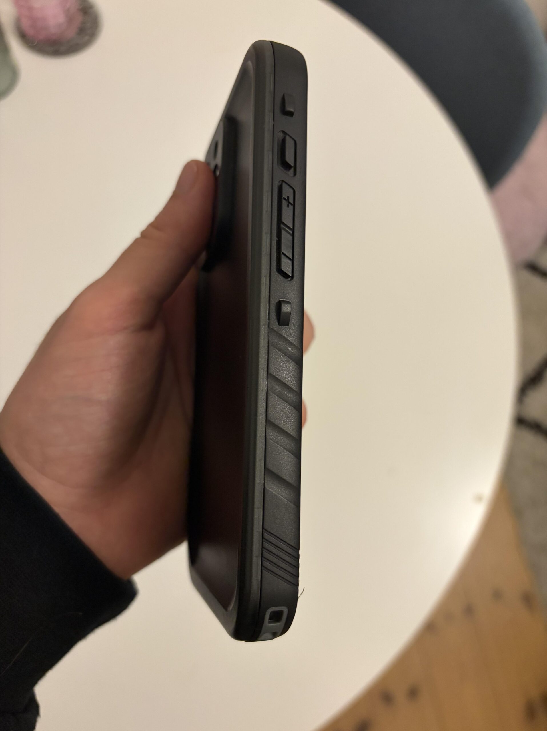 Side view of the volume buttons on my black Cozycase waterproof iPhone 13 Pro case