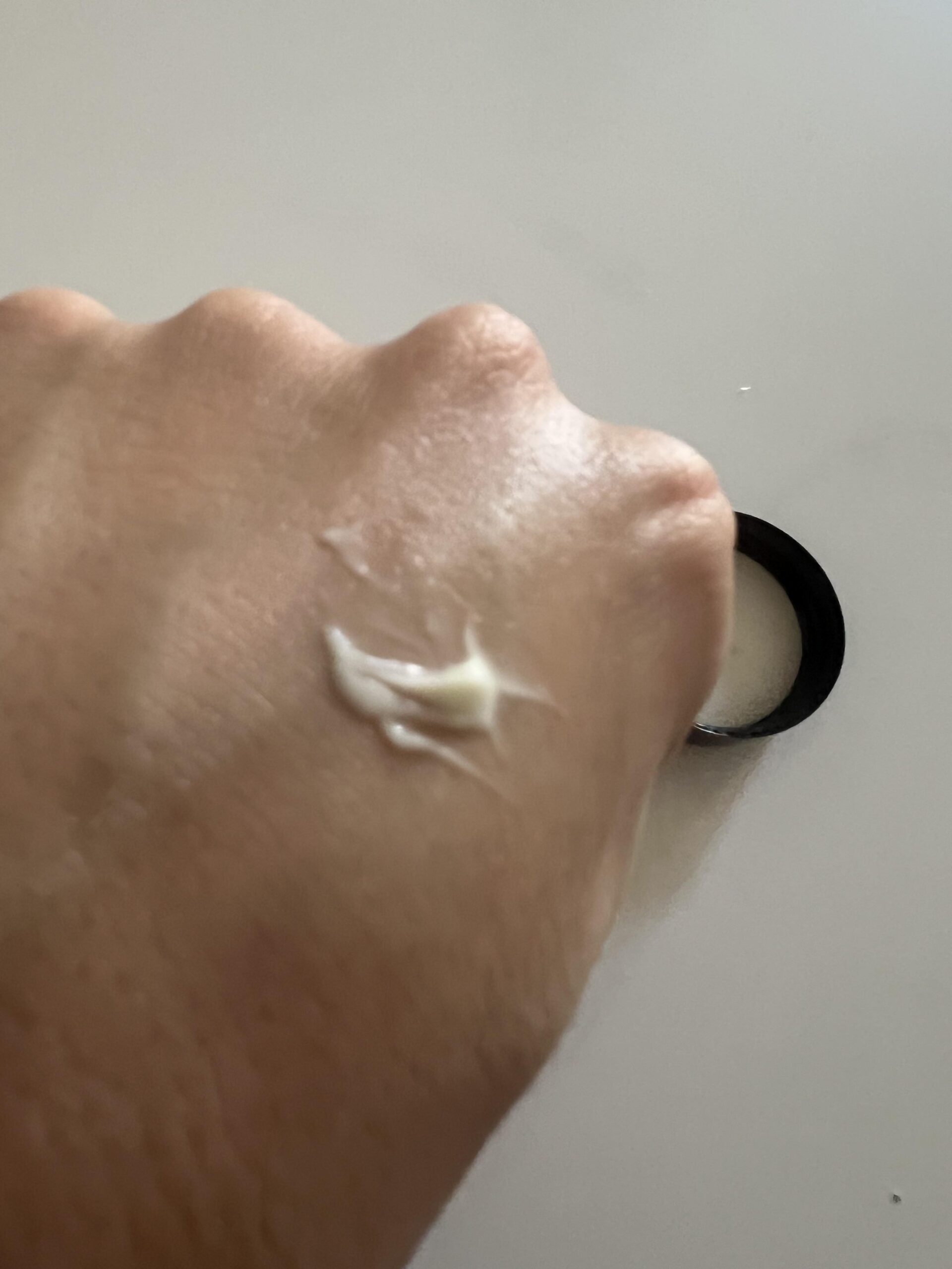 Close-up of dab of Eight Saints eye cream on the back of a hand
