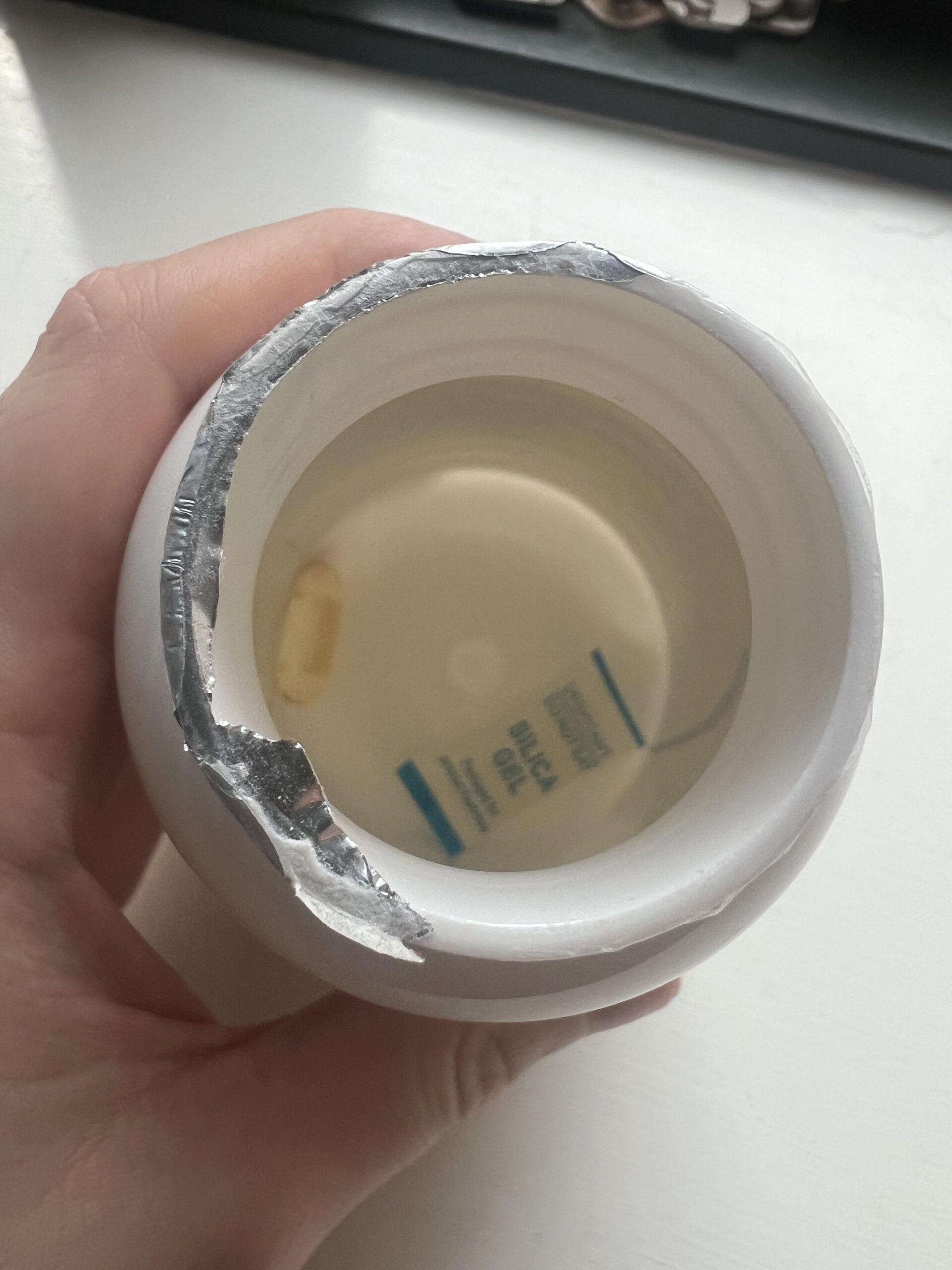 Inside my opened EXVital algae oil capsule bottle showing a partly removed foil liner