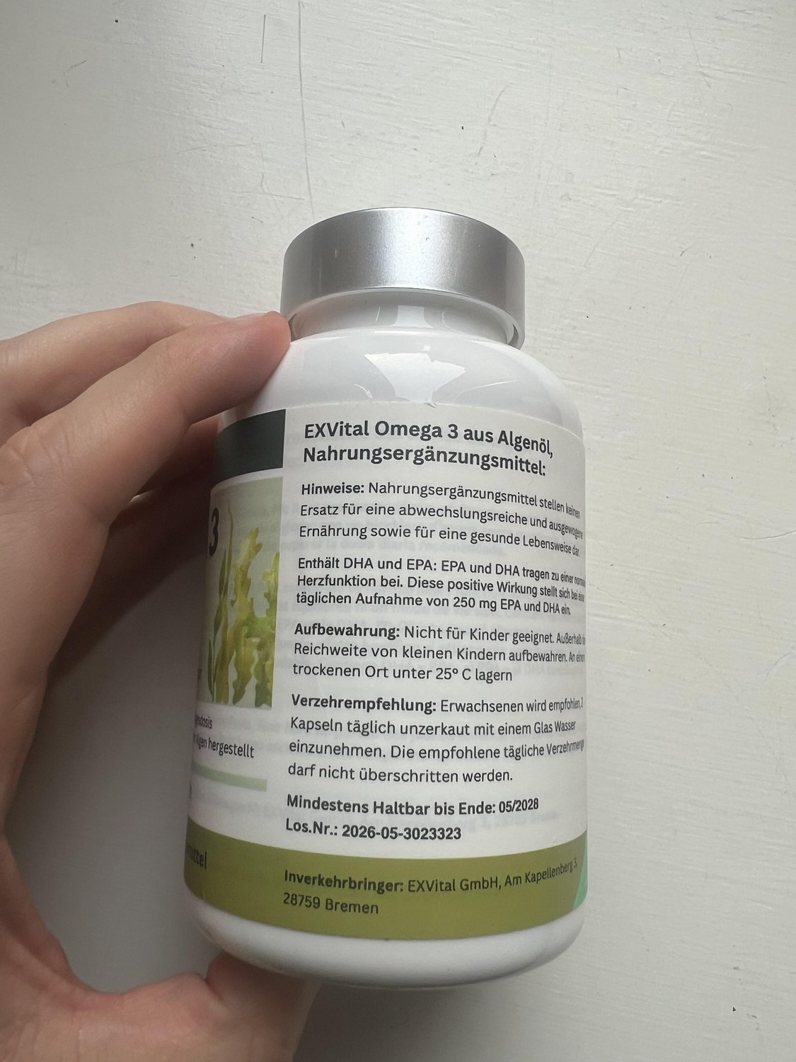 German manufacturer directions on the EXVital algae omega-3 bottle recommending two softgels each day