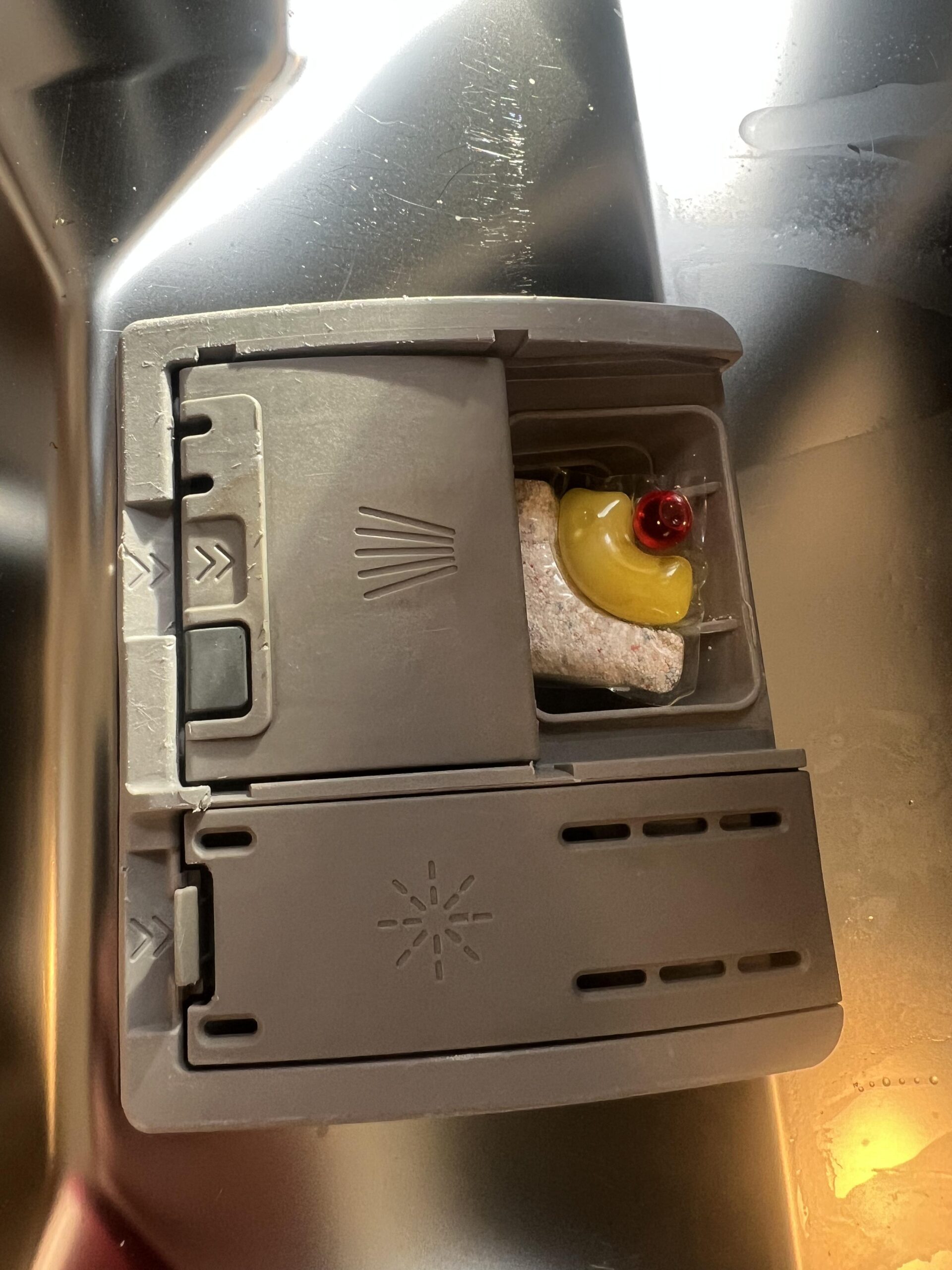 Finish Ultimate Plus Citrus capsule with red Powerball and yellow gel inside my dishwasher detergent dispenser