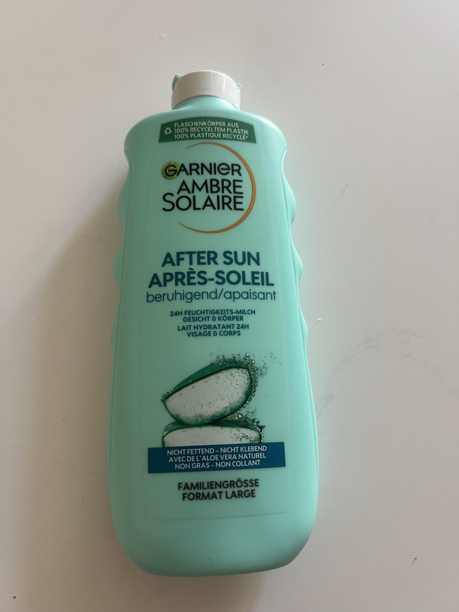 Original photo showing the front of a turquoise Garnier Ambre Solaire After Sun 24h Moisturising Milk 400 ml bottle with aloe vera imagery