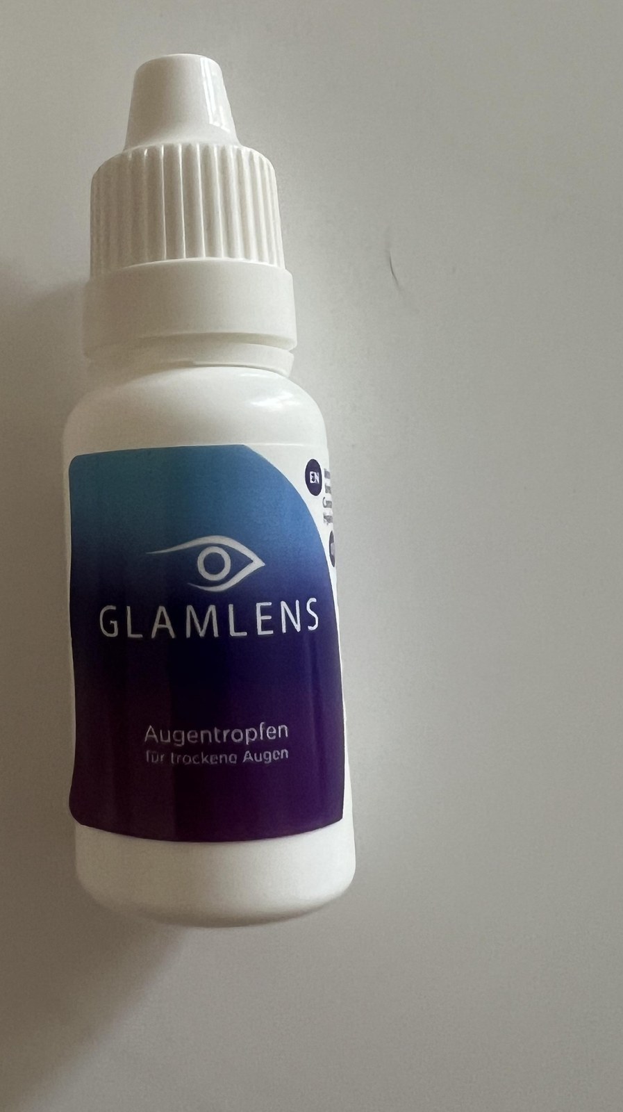 Original photo showing an upright Glamlens 15 ml eye drops bottle with the purple and blue Glamlens front label clearly visible