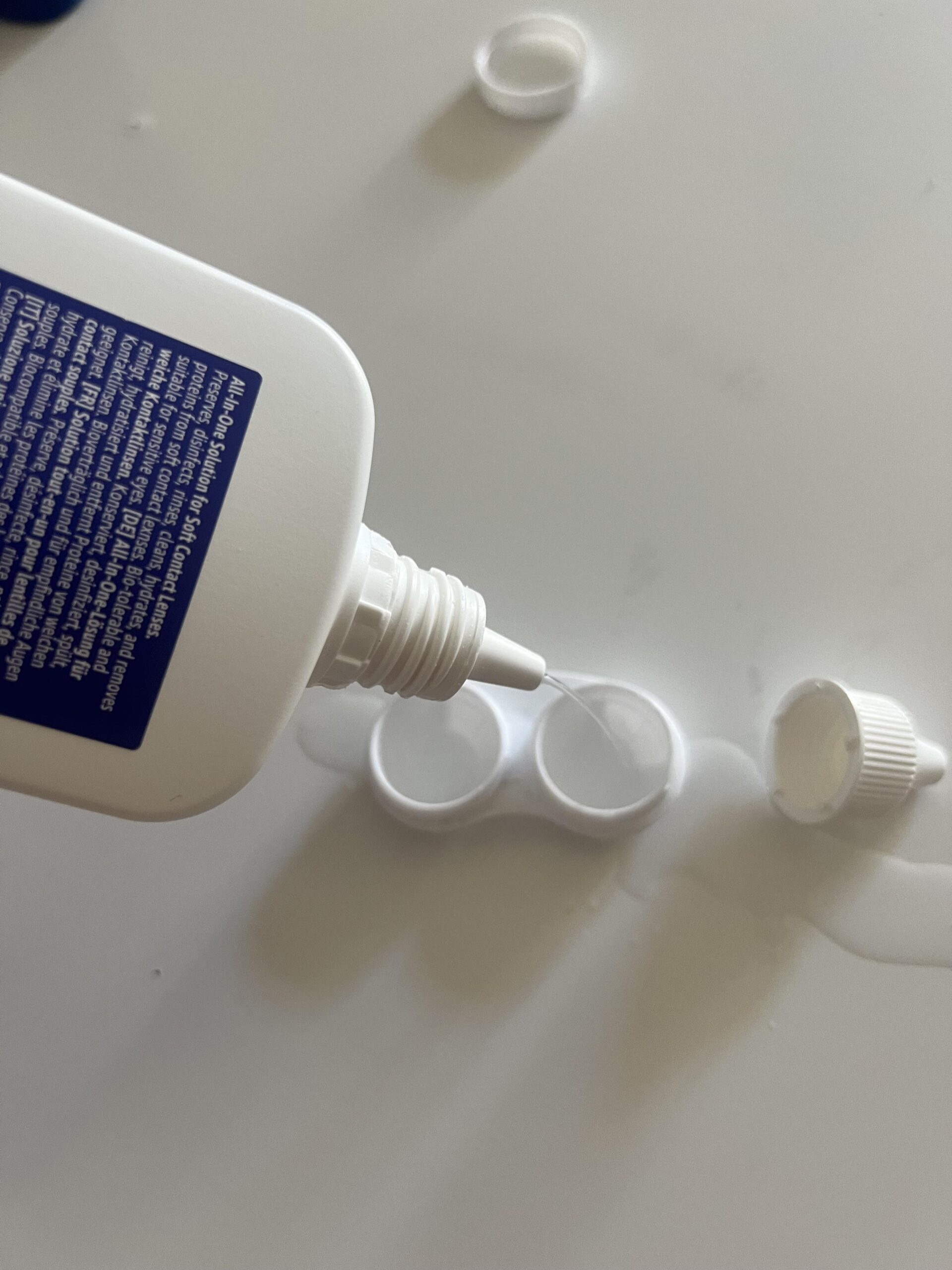 My Healthcare by Amazon contact-lens solution bottle tilted toward an open soft contact lens case