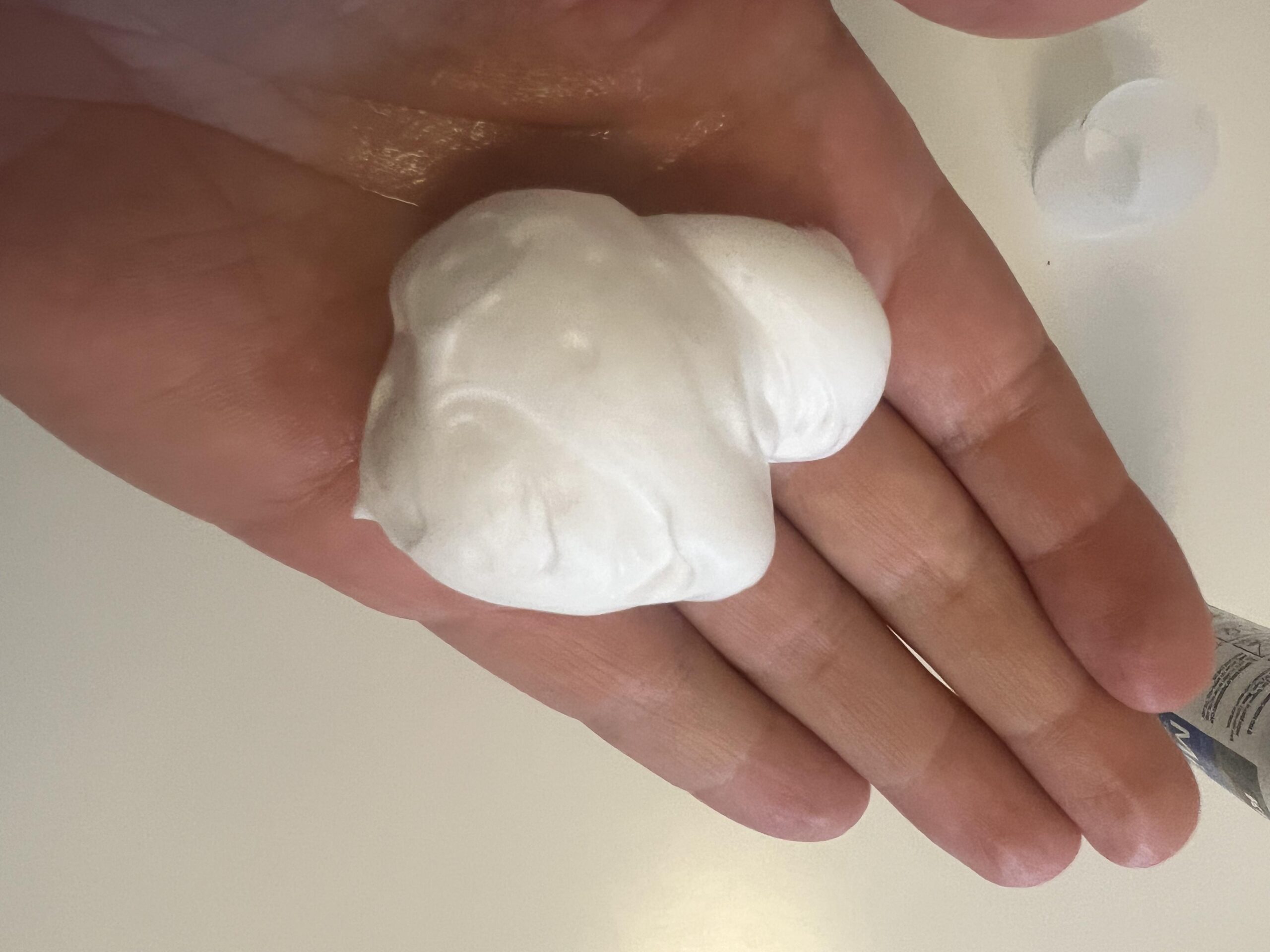 White Kirkland five percent minoxidil foam dispensed into the palm of my hand