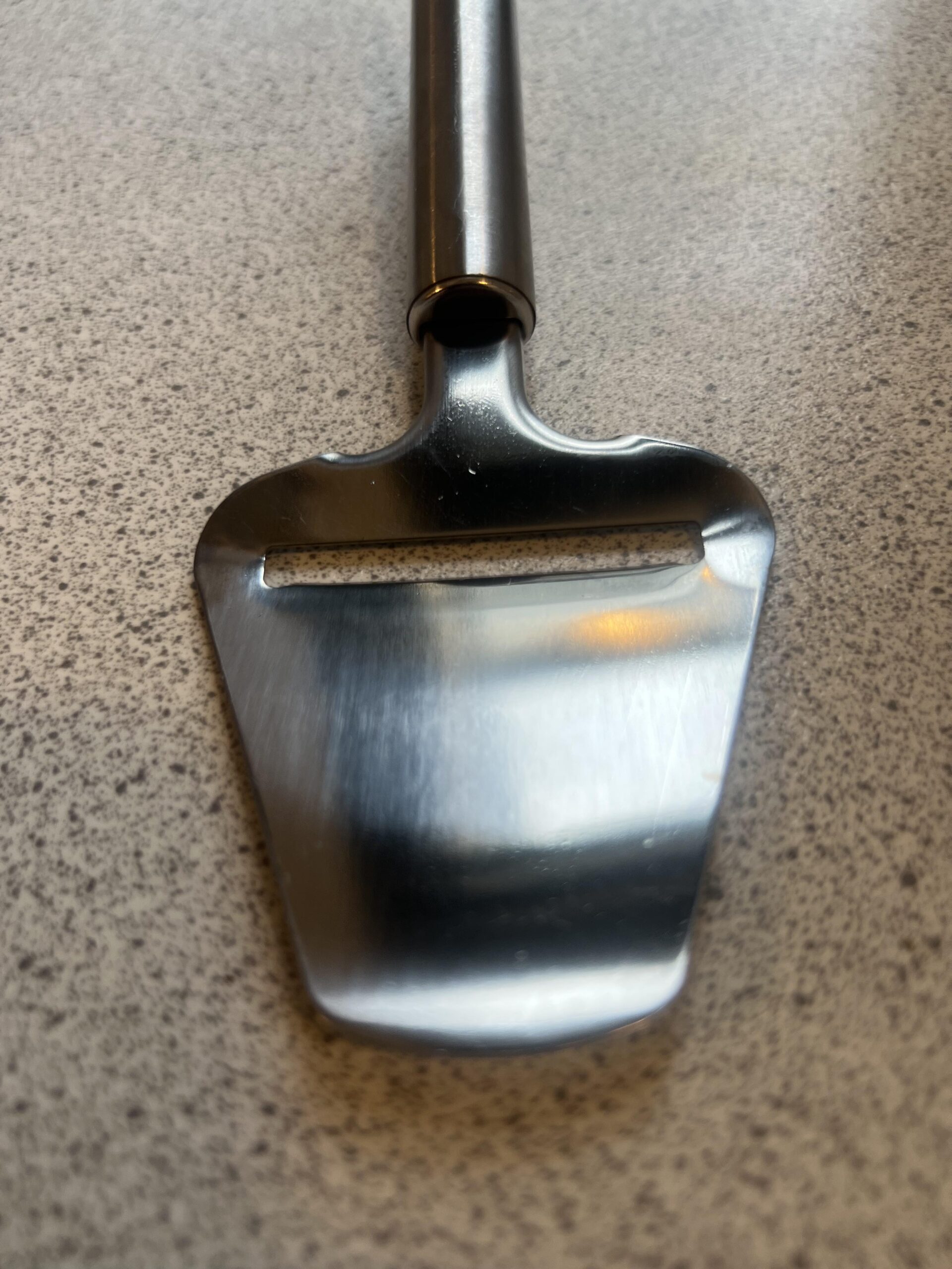 Close view of the metal cutting slot on my LAMXD cheese slicer