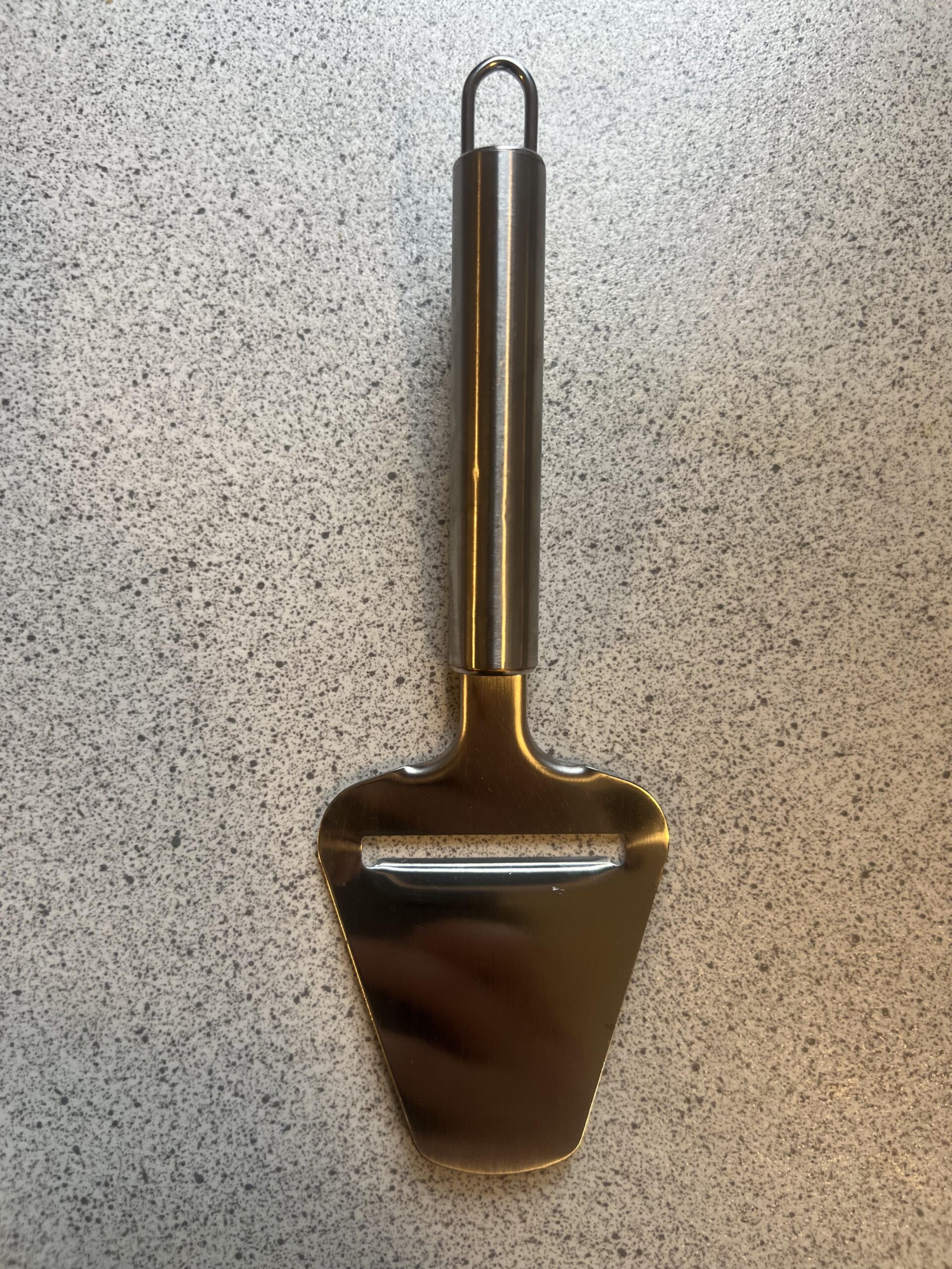 Back of my LAMXD metal cheese slicer showing its metal handle and hanging loop