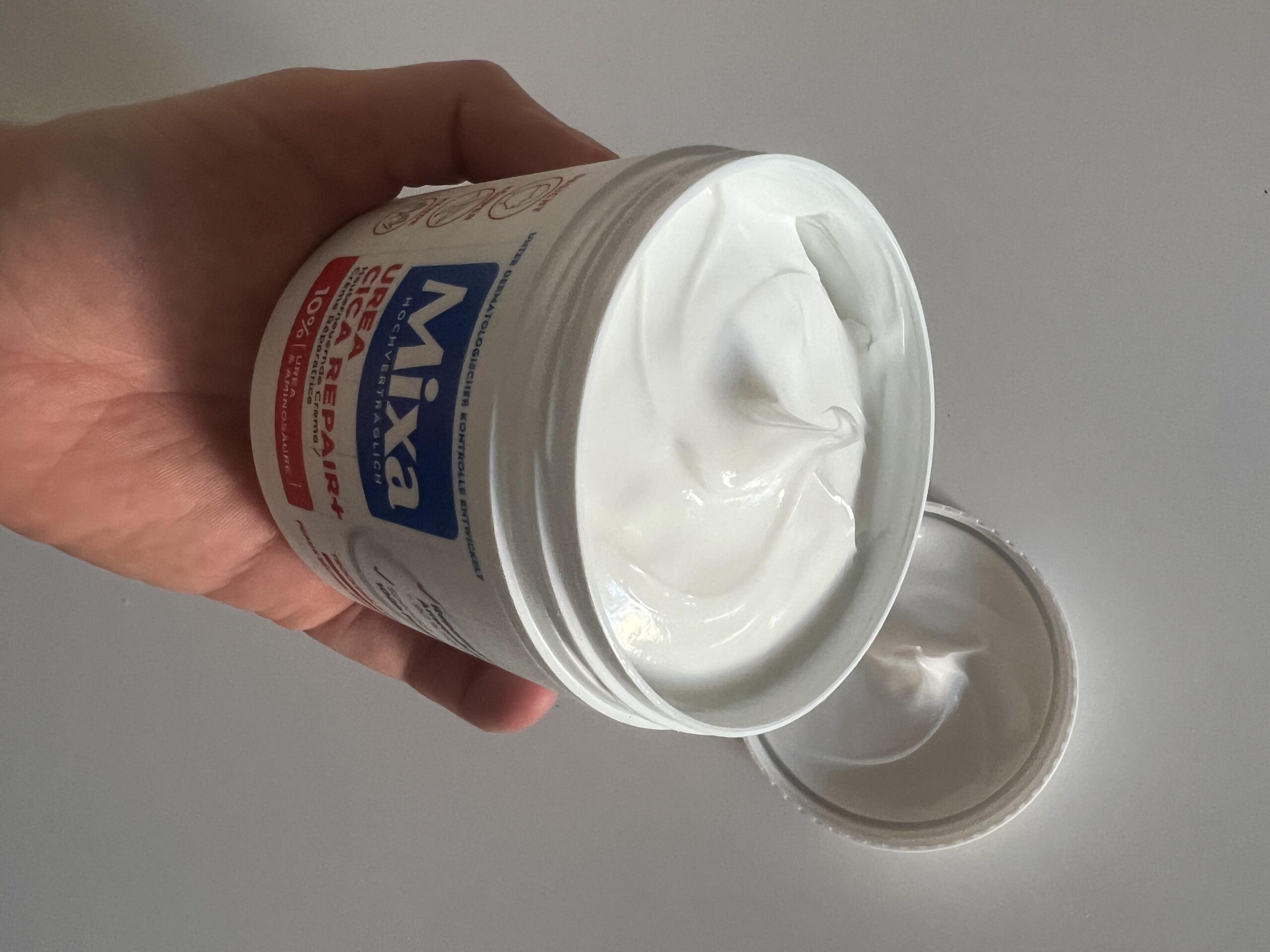 My opened Mixa cream jar showing thick white cream