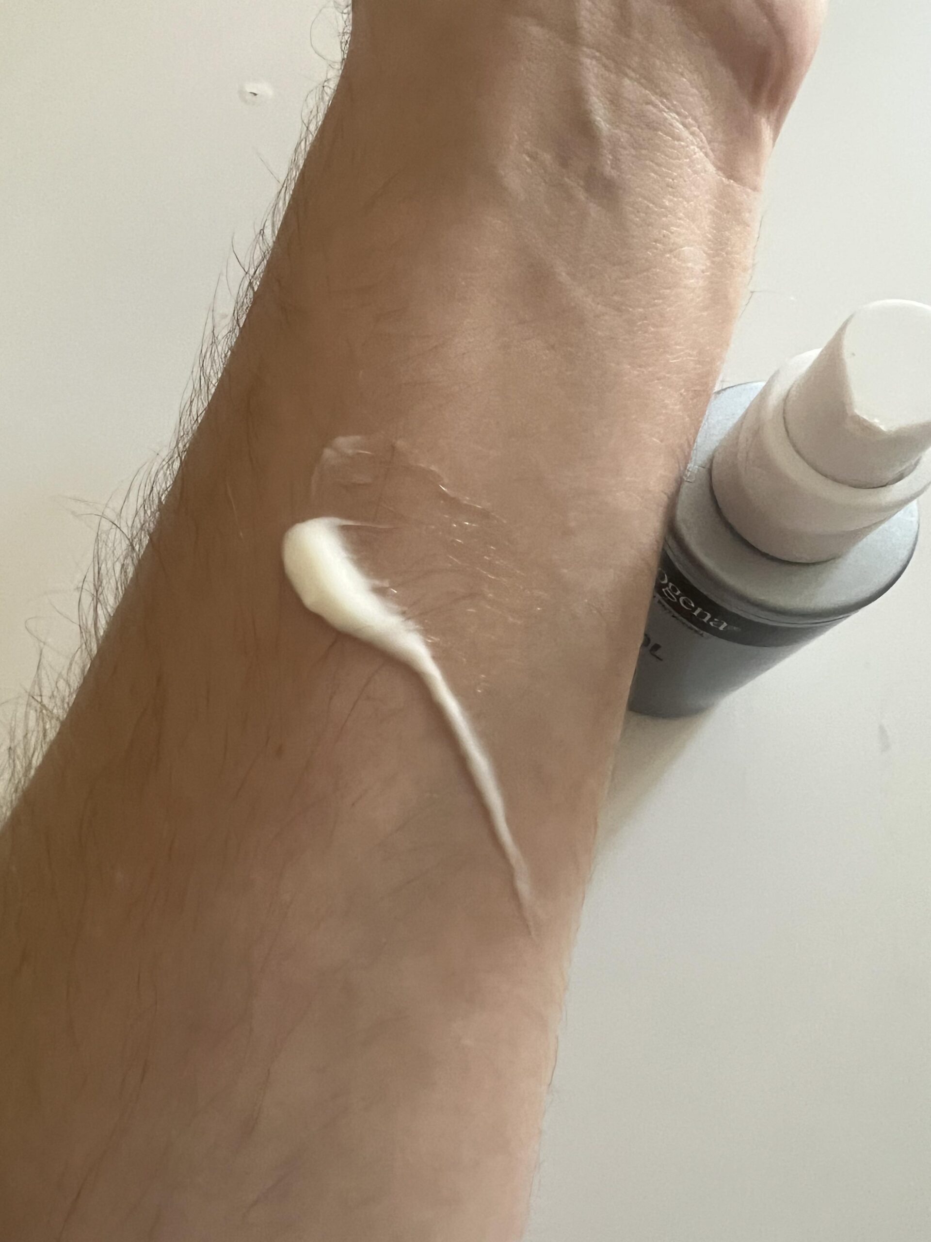 My original close-up photo of Neutrogena Retinol Boost cream spread partly on my forearm