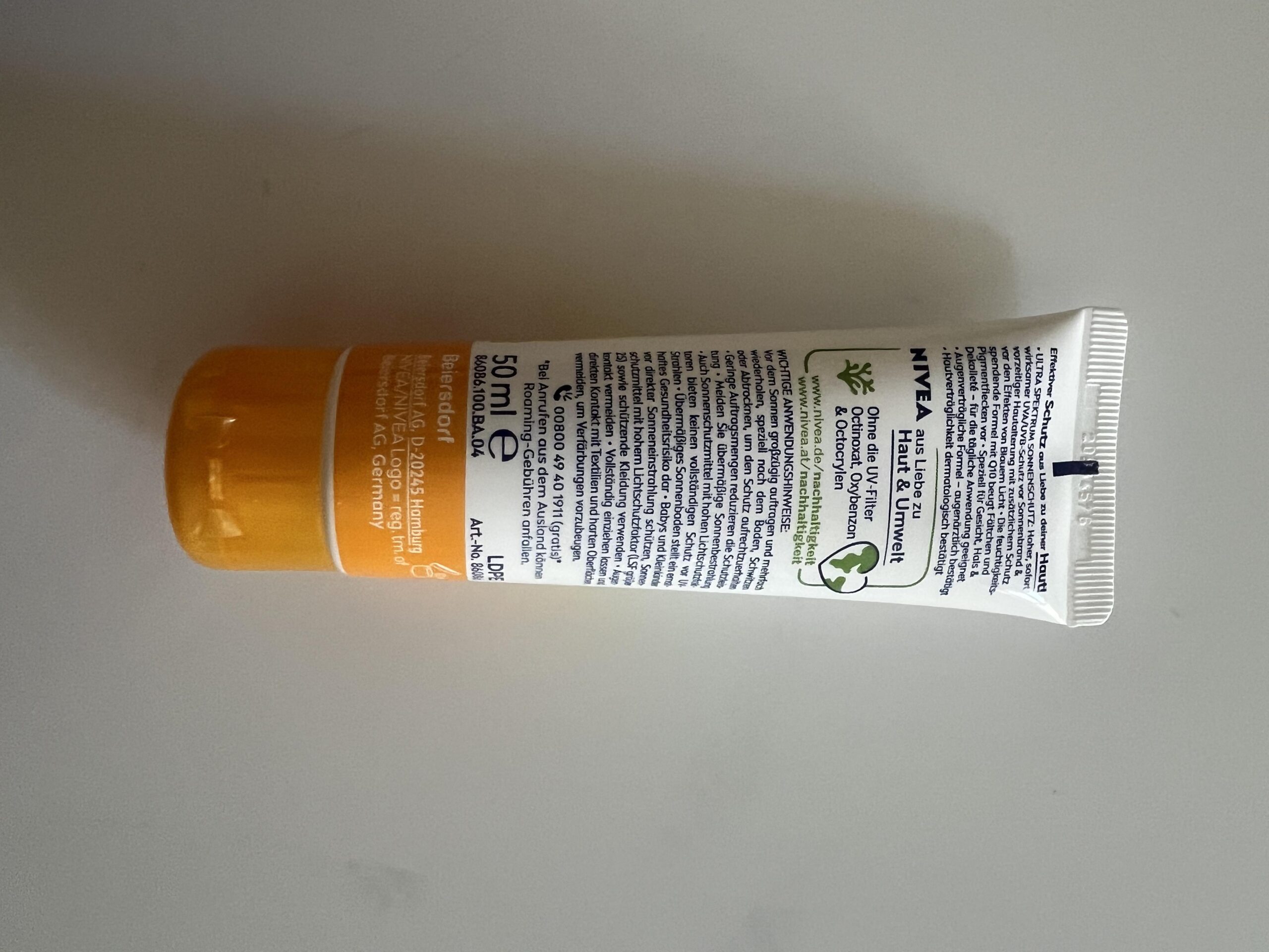 Original photo of the back of NIVEA SUN UV Gesicht Q10 Anti-Age Sonnenschutz SPF 50 showing German precautions and 50ml size