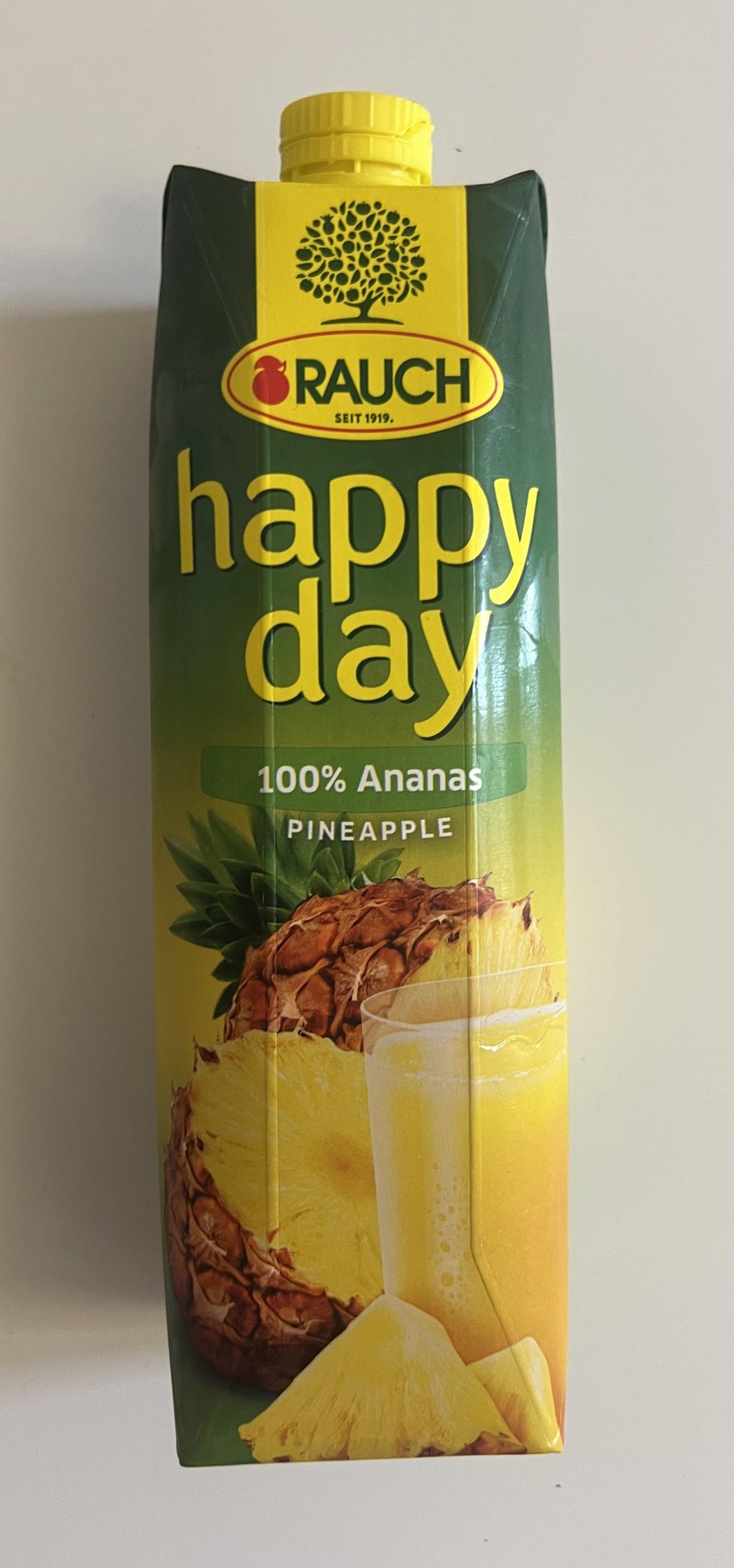 Original Rauch Happy Day 100 percent pineapple juice carton standing upright