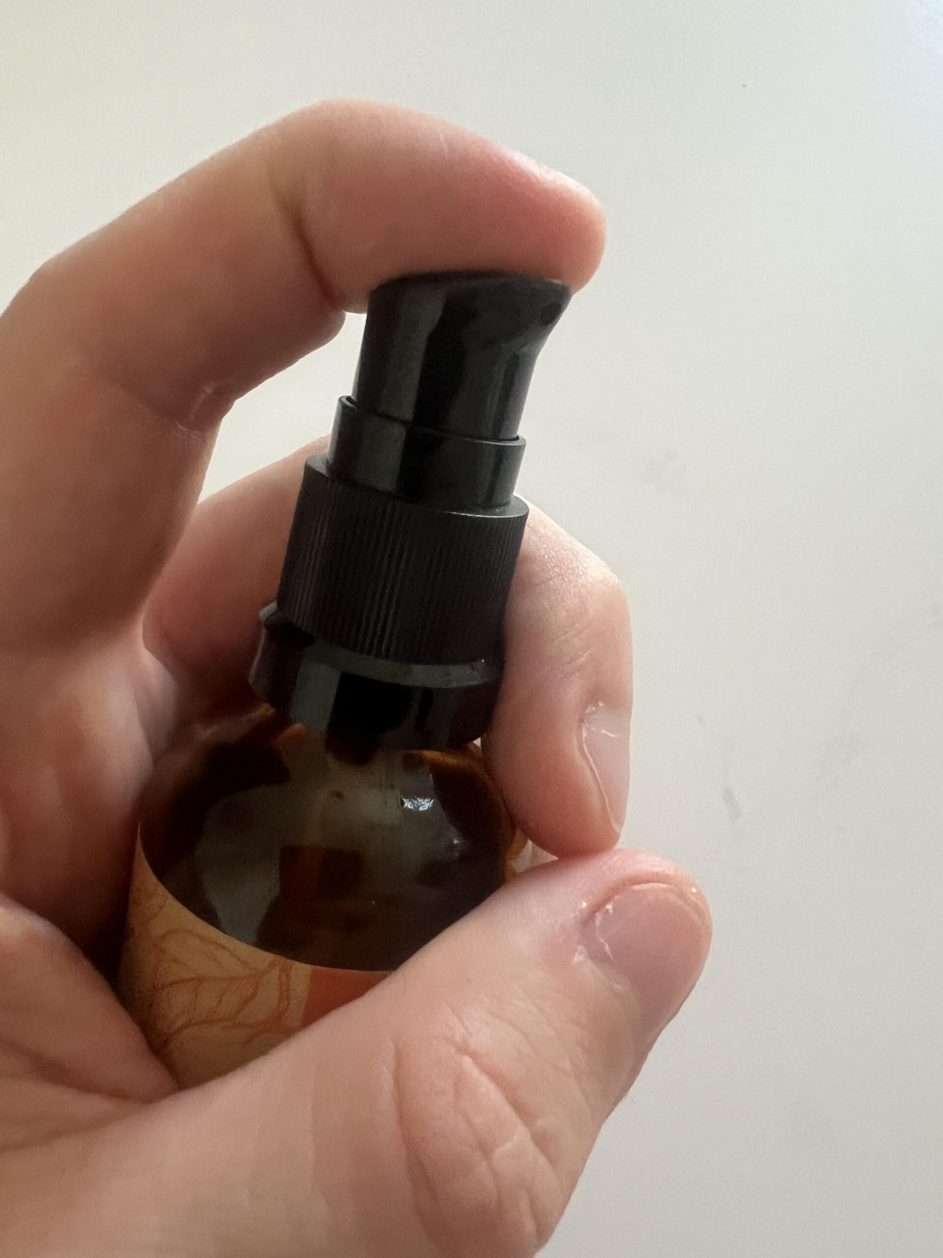 My Soena Naturals vitamin C serum pump dispenser held in my hand