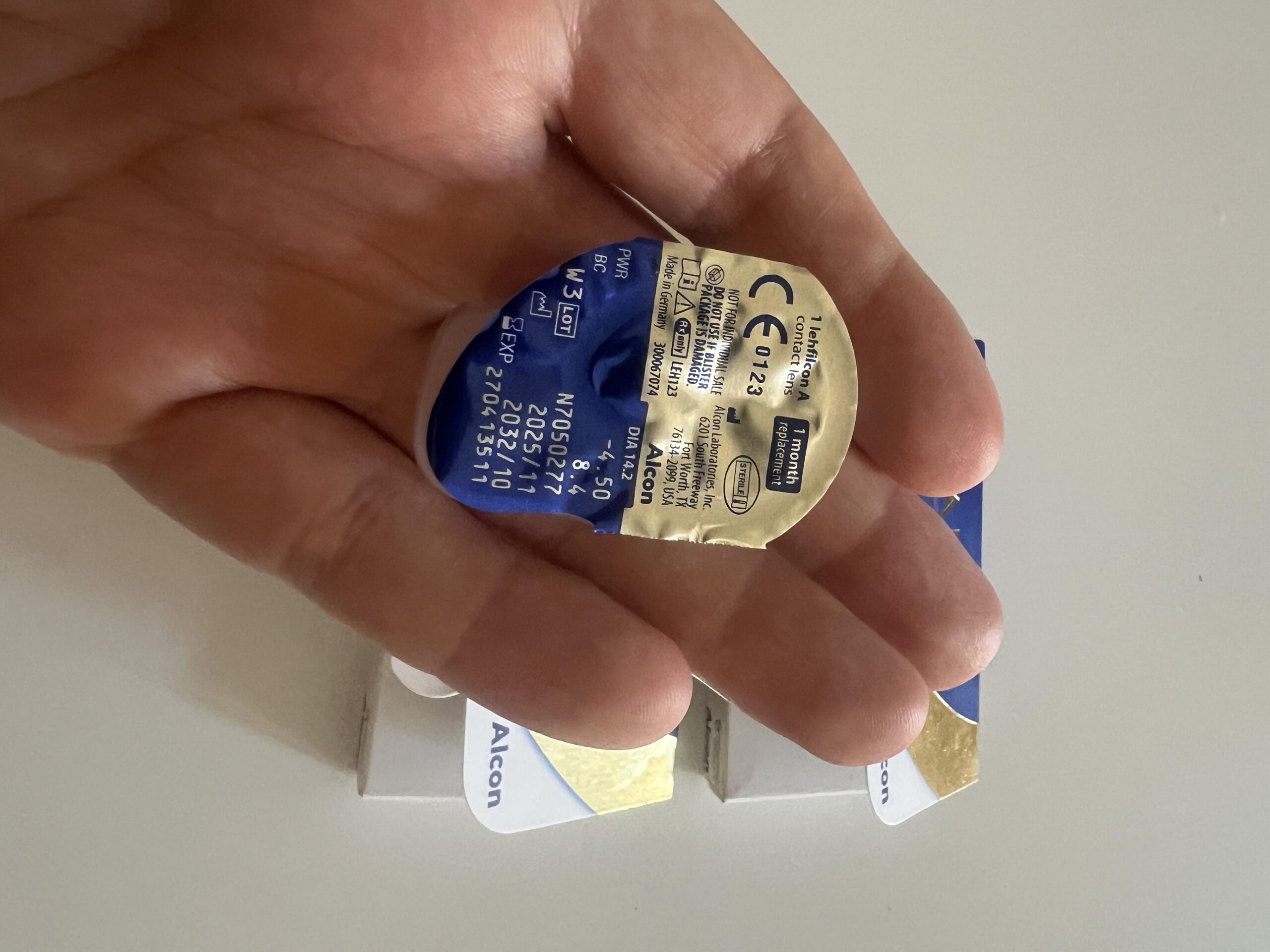 My individually sealed TOTAL30 contact lens blister with printed foil label, held in my hand
