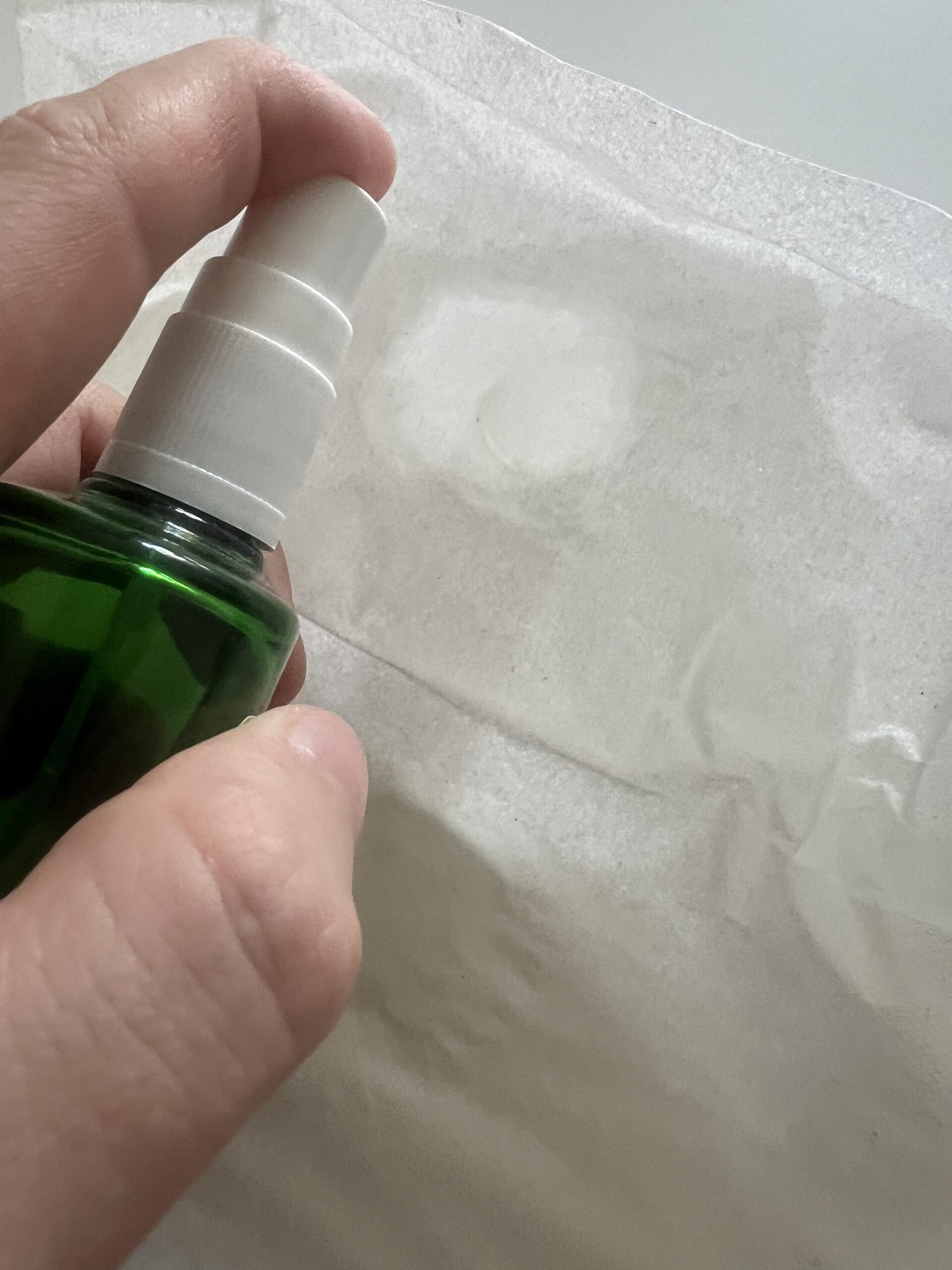 Original photo of my Weleda Citrus Fresh Deo Spray bottle dispensing product toward a piece of tissue